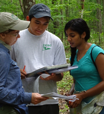 2 students reading datasheet in forest