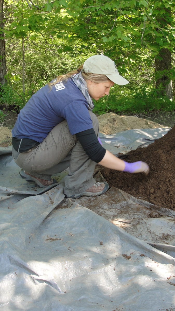 [Heather collecting soil for use in her group project on soil processes and climate change.]
