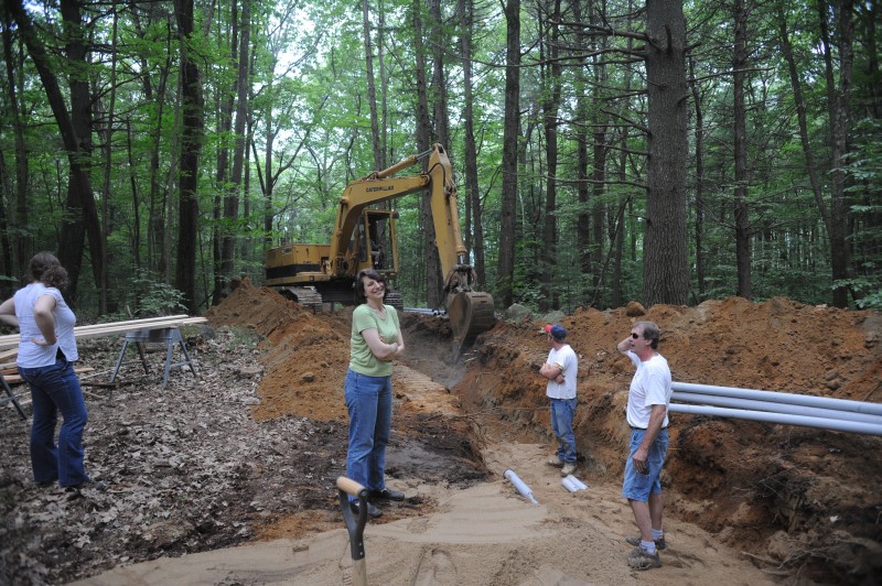 [Construction of the chamber array has involved installation of new infrastructure. For example, a new, underground primary electric line had to be run from Locust Opening Road to the chamber site. Shown here are (left to right) data analyst Liza Nicoll, Director of Administration Edythe Ellin, and our two electricians (Neil Hampson on the right).]