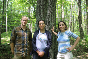 three scientists standing in front of the Witness Tree