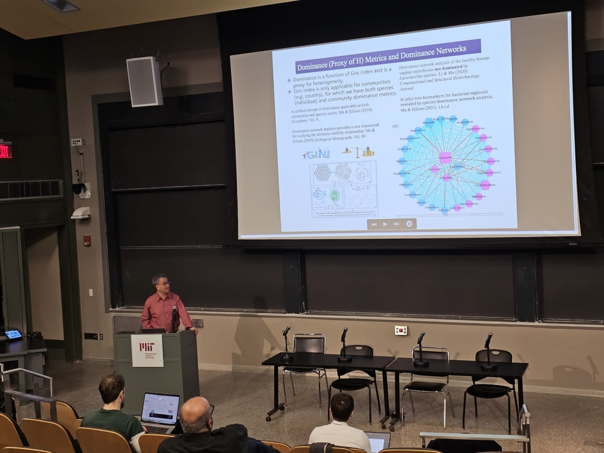 Image shows Dr. Ma presenting at MIT.