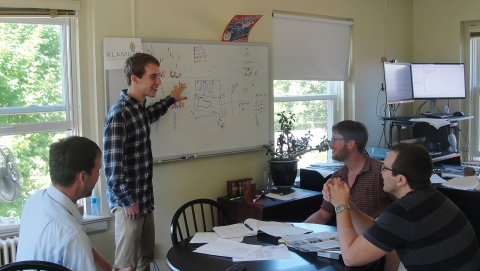 Summer Student discusses research with mentors