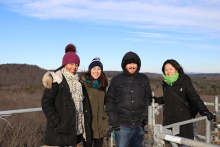 Interns pose for a picture over tree level during a field walk.