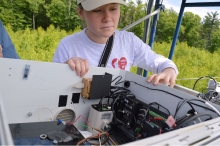 2016 Summer Student Alex Widstrand inspects the above-canopy tram. Photo by Lauren Ebels.