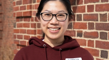 Image shows Cynthia Liu in front of the Harvard Forest Fisher Museum.
