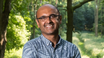 Image shows Professor Yadvinder Mahli standing in the woods.