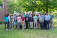 Interns participating in the 2024 Summer Research Program in Ecology stand outside on Harvard Forest's campus.