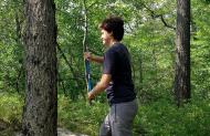 A person taking a sample from a tree.